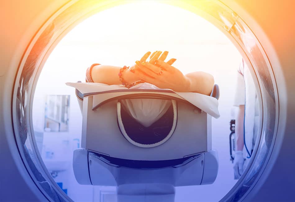 A person going through a CT Scan or MRI machine.