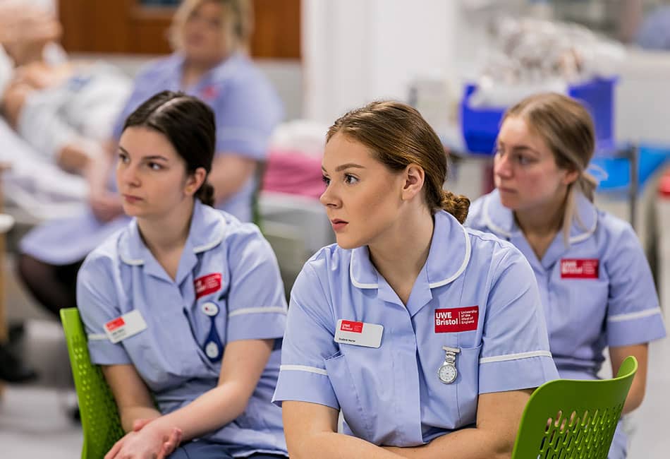 Three students wearing nurse uniform.