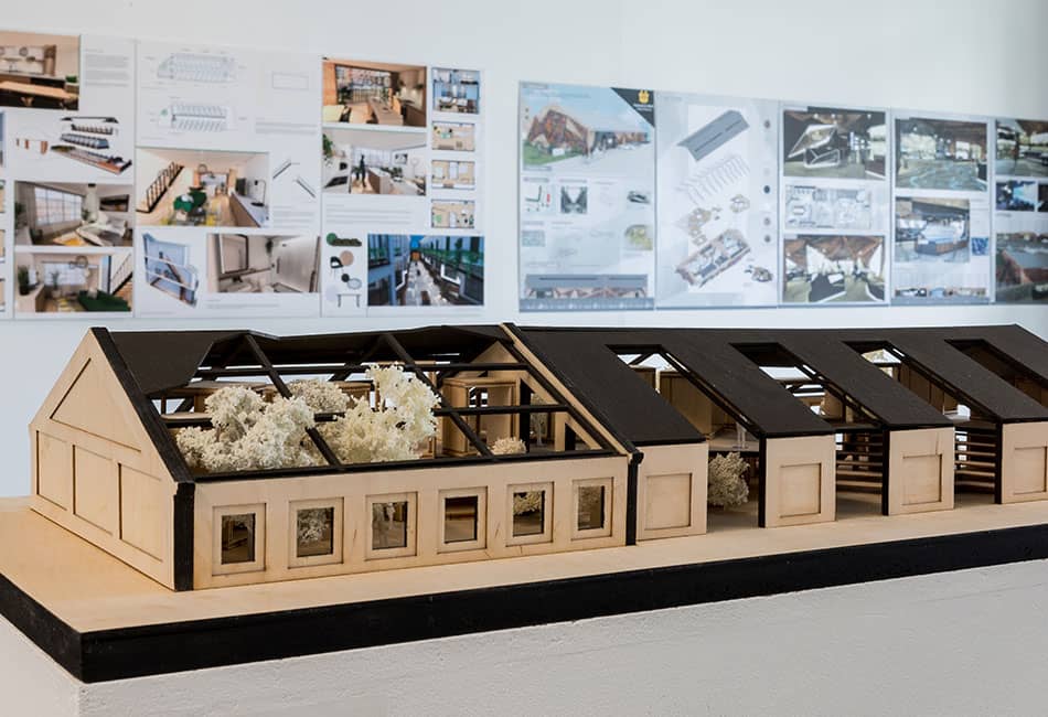 A small prototype of a house being displayed in a room.