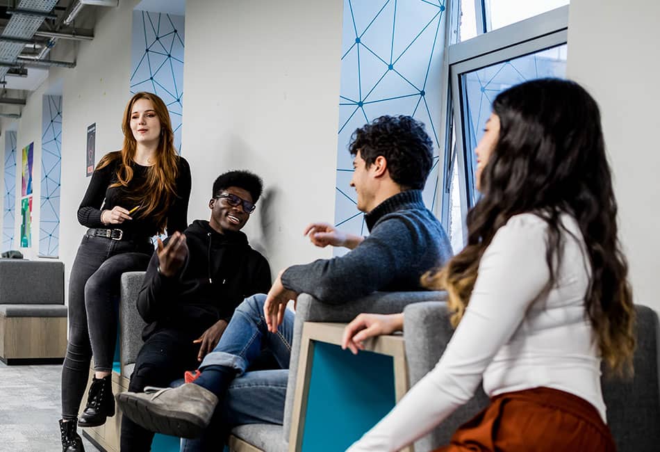 Four students talking to each other.