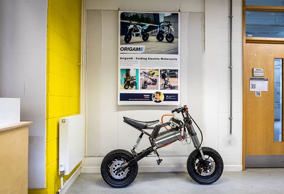 A small motorcycle under a display board in a room.